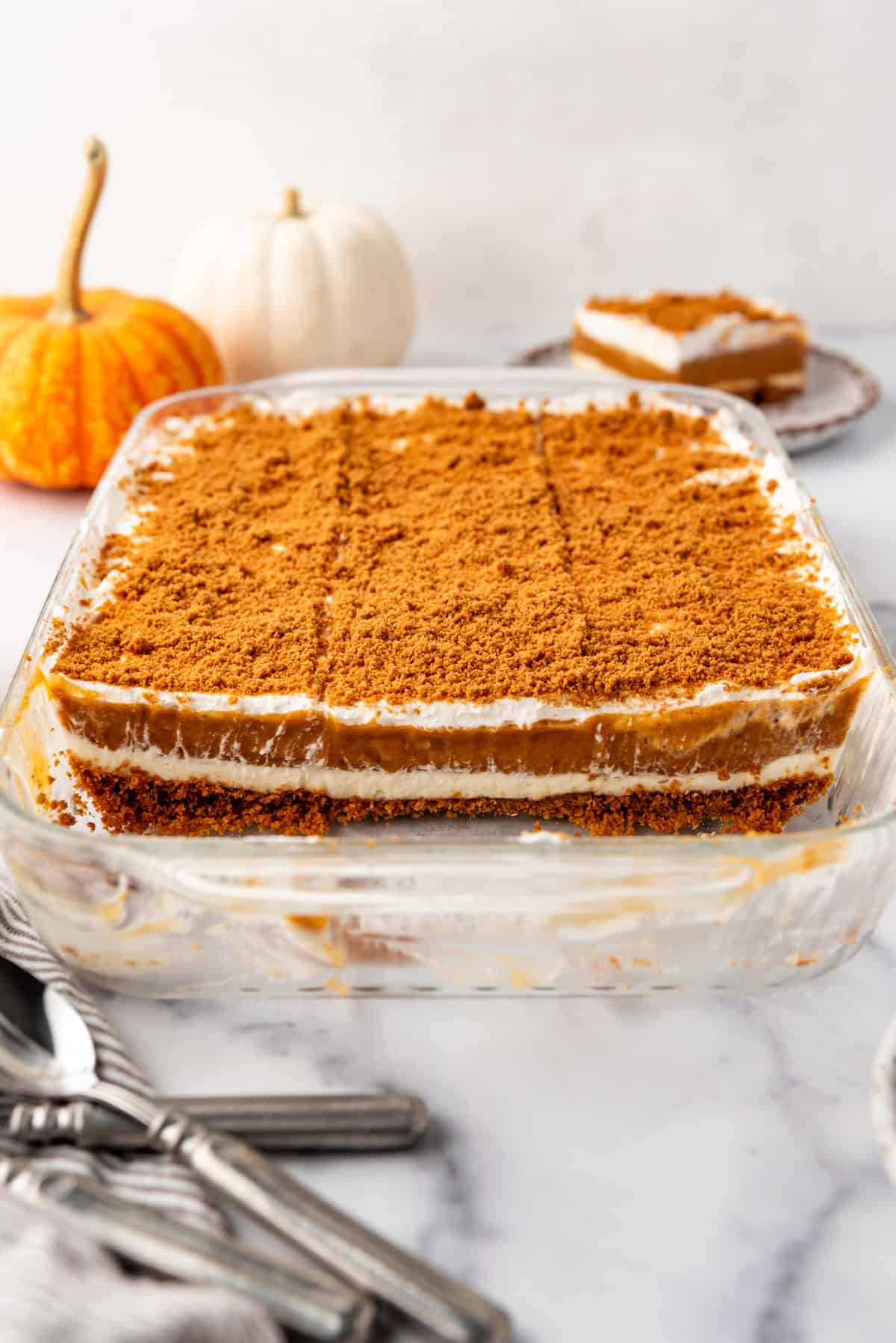 A finished and set pumpkin delight dessert with some slices removed.