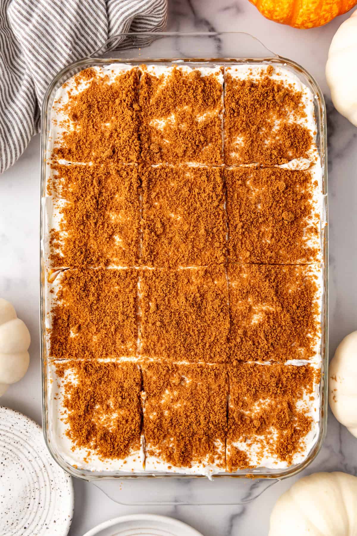 An overhead image of a pan of pumpkin delight cut into squares.