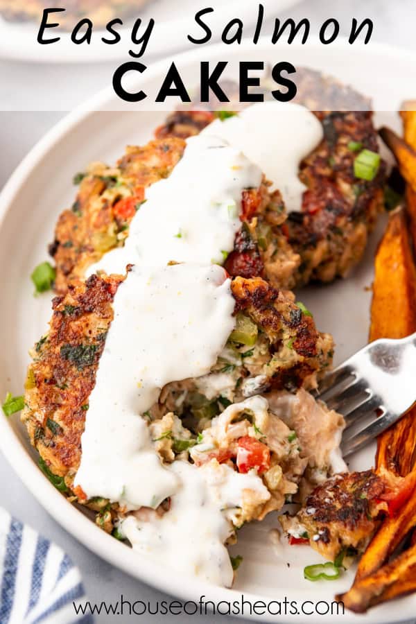 Salmon cakes on a plate with a fork and a white sauce with text overlay.