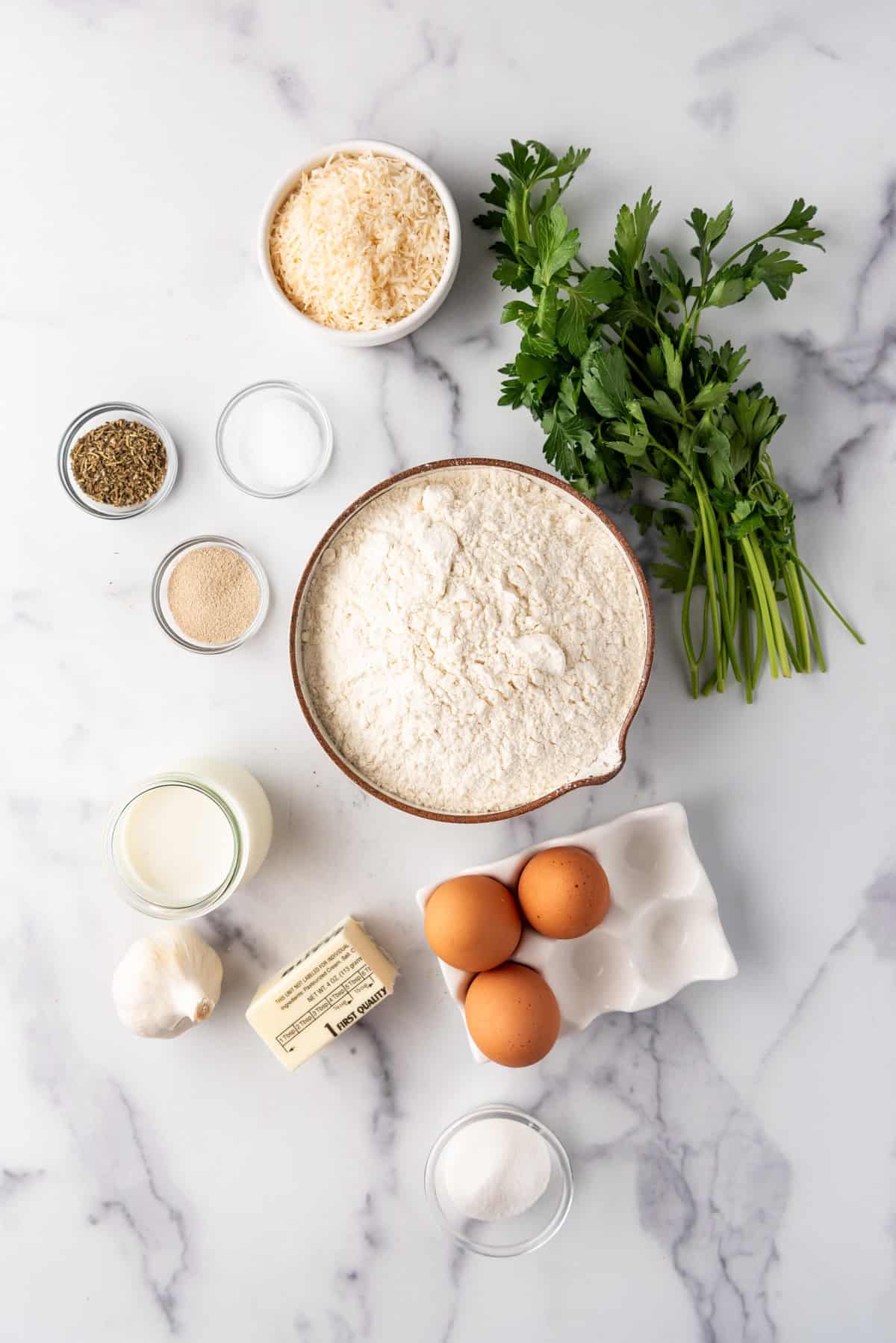 Ingredients for making a loaf of swirled garlic herb bread.