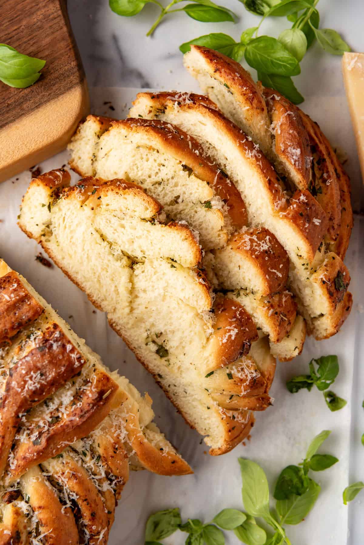 Slices of swirled garlic herb bread leaning against each other.