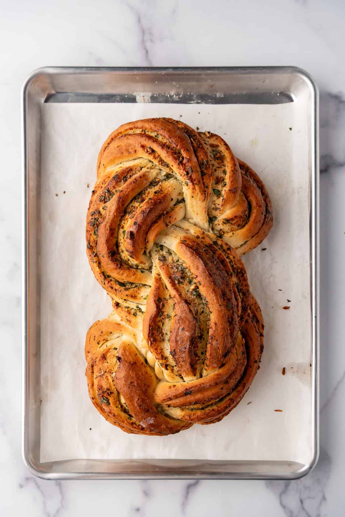 A baked loaf of garlic herb bread.