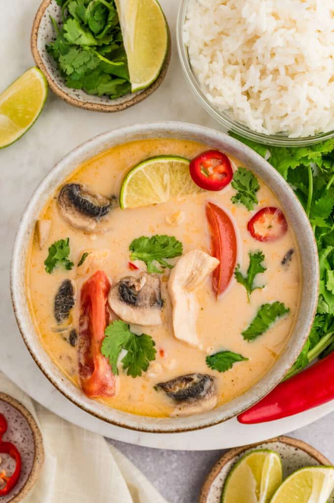 An overhead image of a bowl of Thai coconut chicken soup.