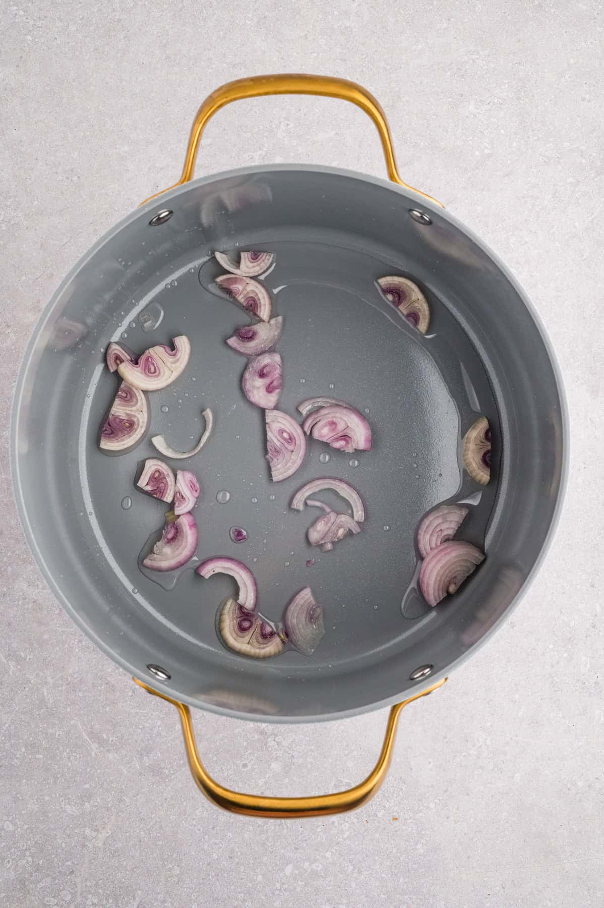 Sauteing shallots in a large pot.