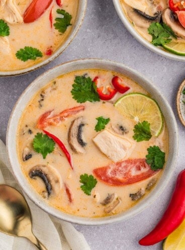 An overhead image of bowls of Thai coconut chicken soup.