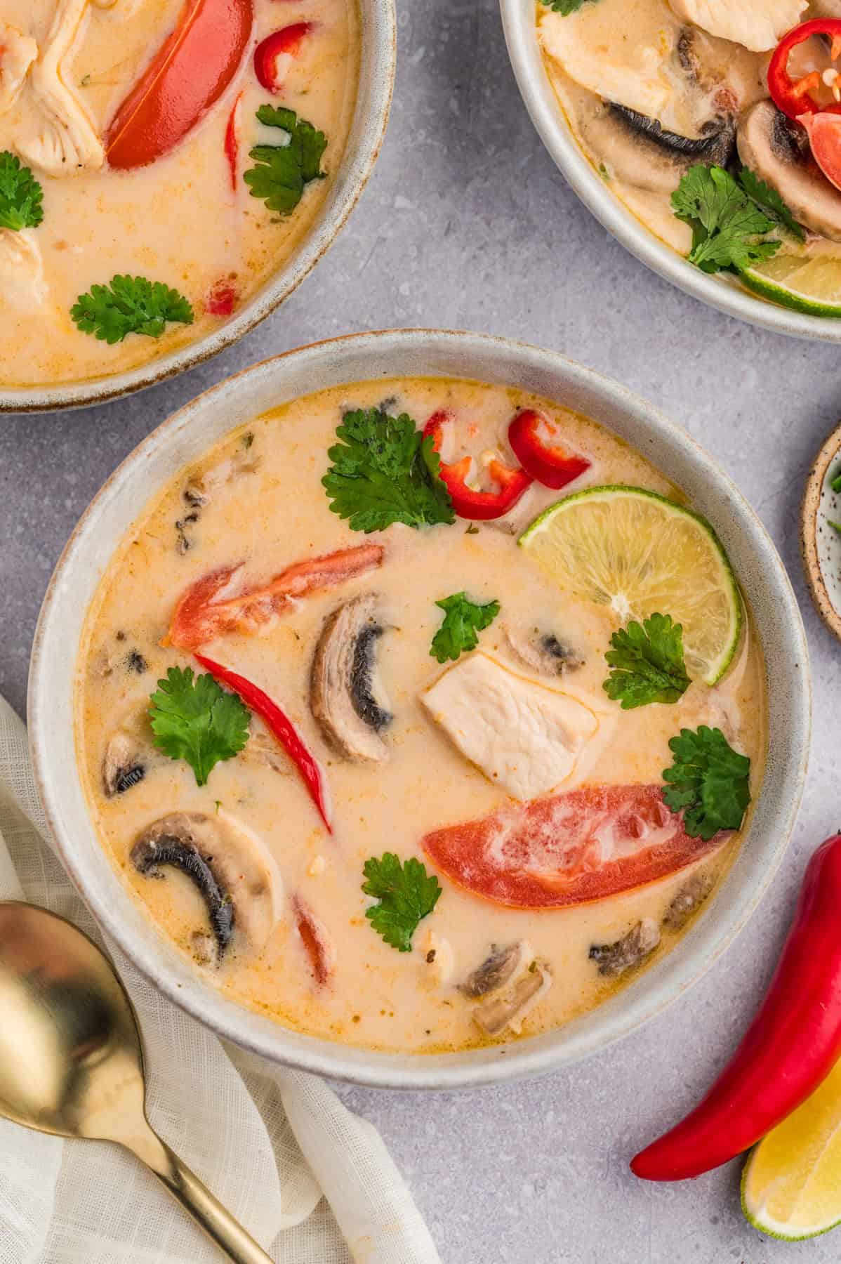 An overhead image of bowls of Thai coconut chicken soup.