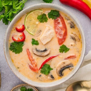 An overhead image of a bowl of tom kha gai soup.