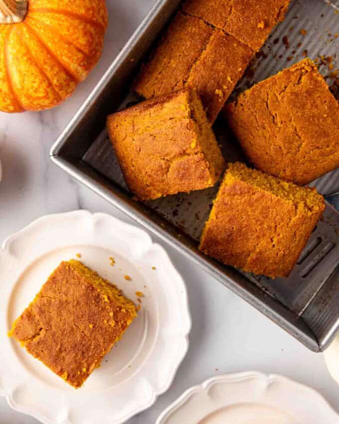 An overhead image of slices of pumpkin cornbread in a pan.