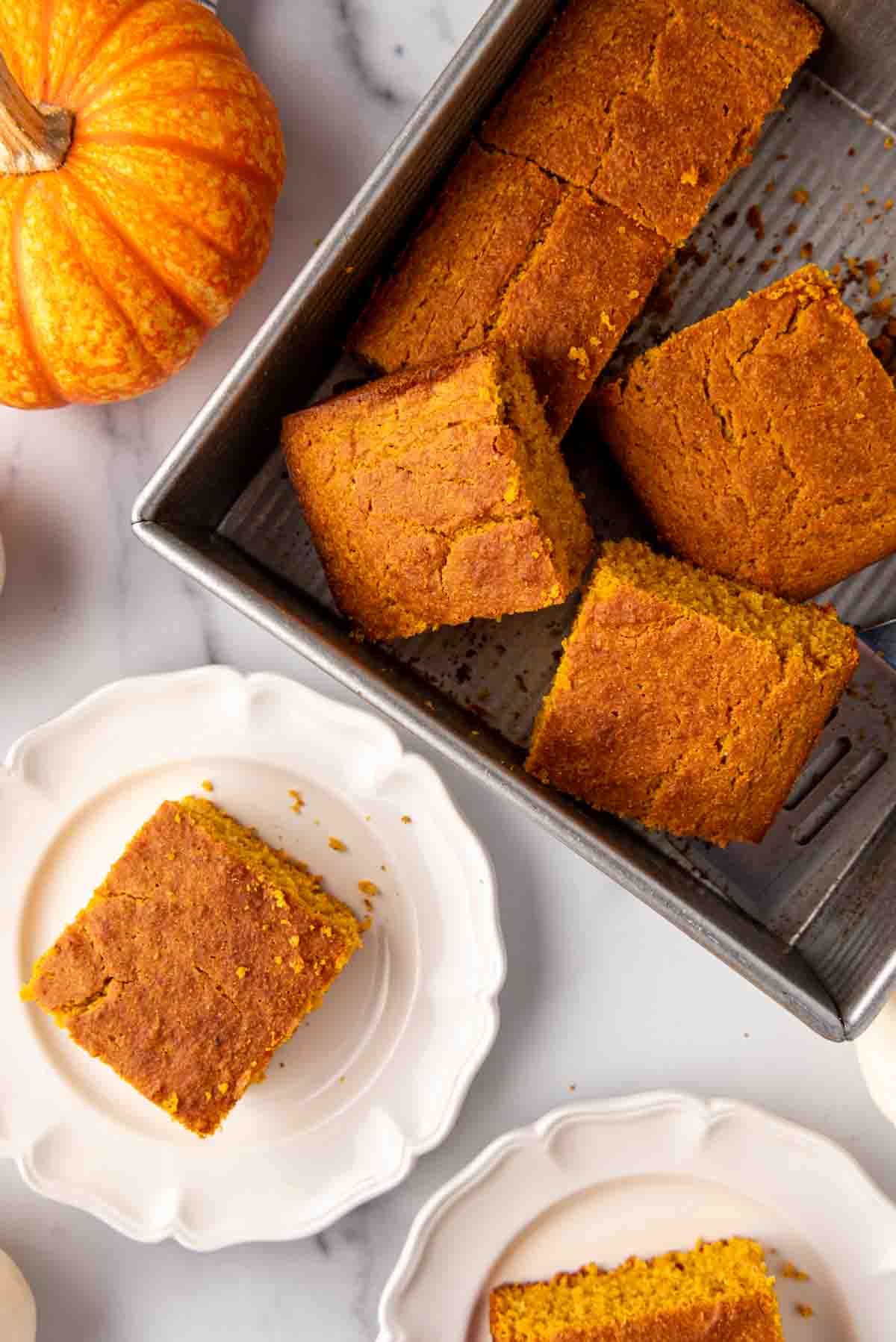 An overhead image of slices of pumpkin cornbread in a pan.