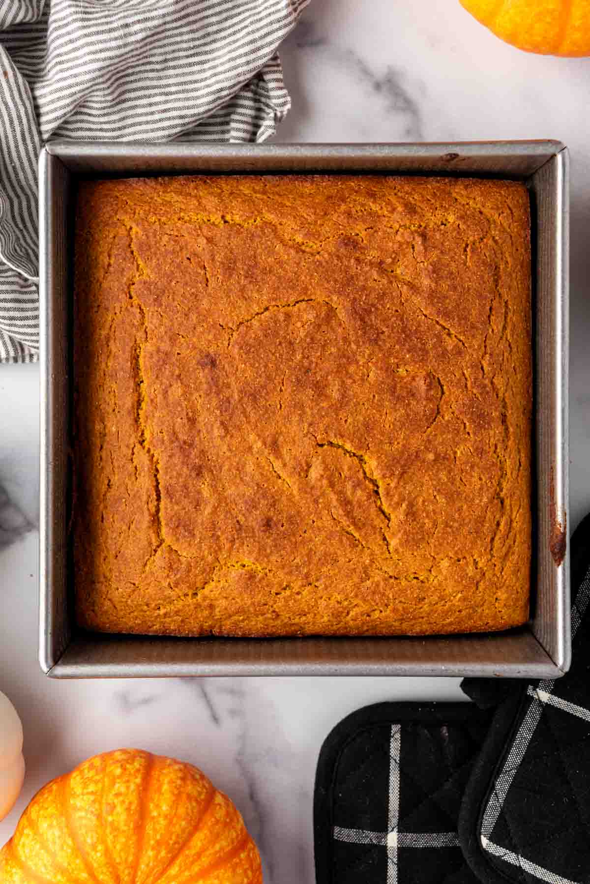 An overhead image of a pan of baked pumpkin cornbread.