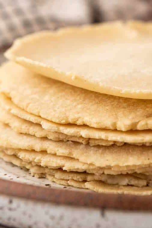 A side image of a stack of homemade corn tortillas.