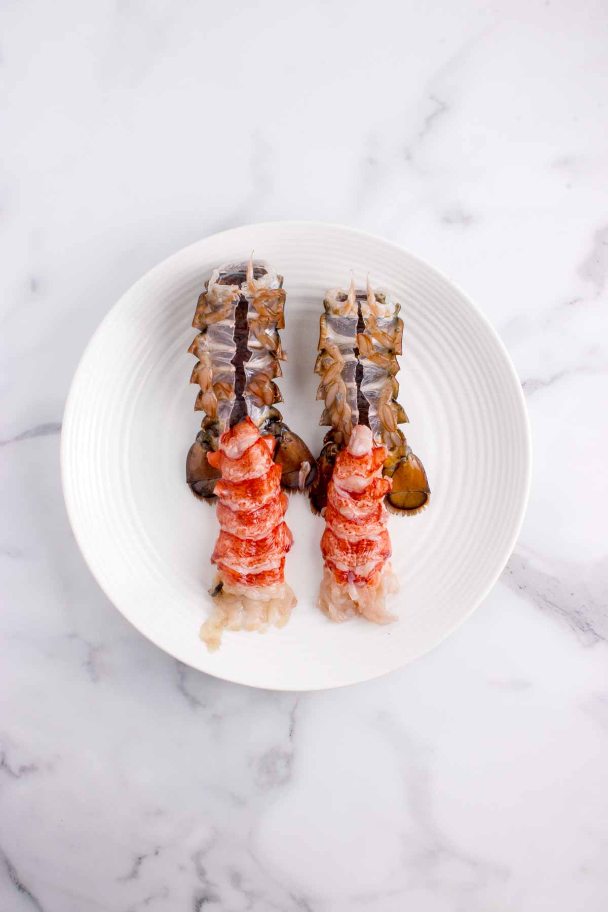 A plate with two lobster tails.