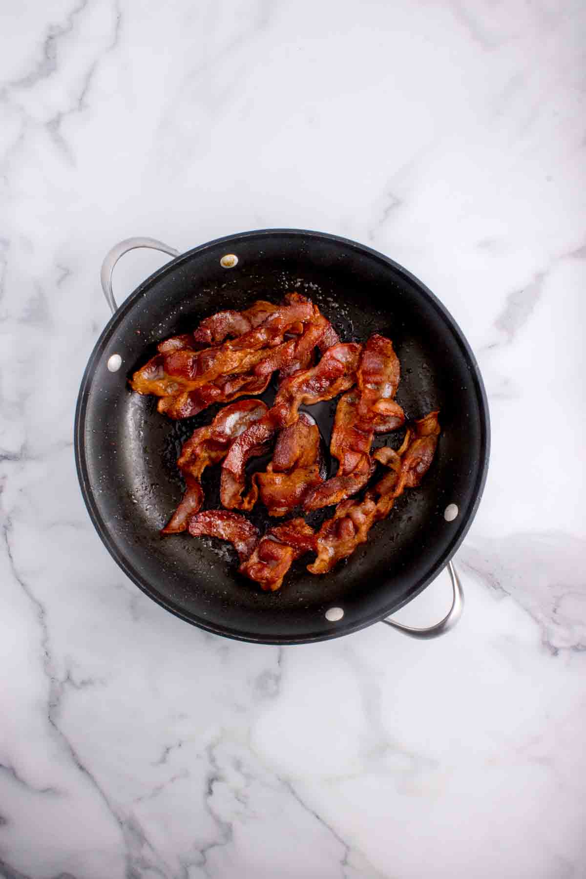 Crispy cooked bacon in a pan.