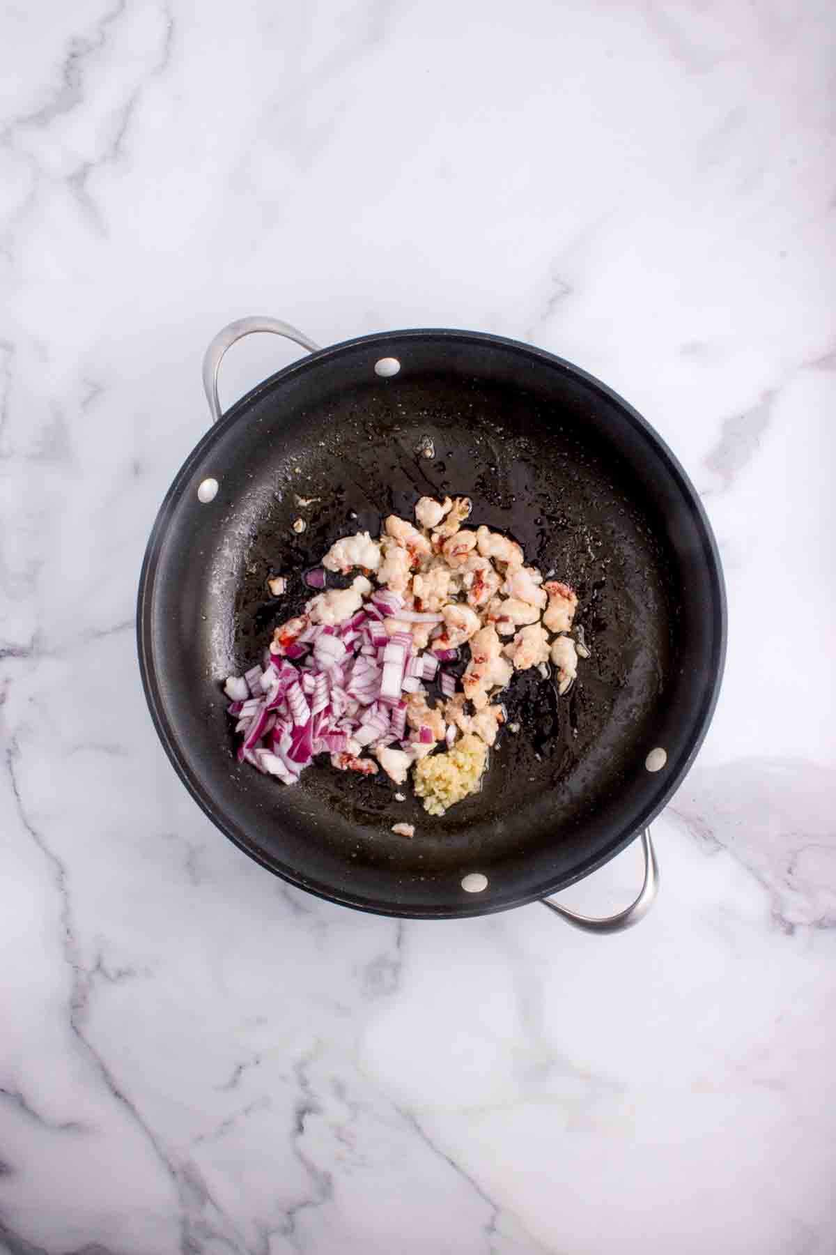 Sauteing garlic and onion in a pan.