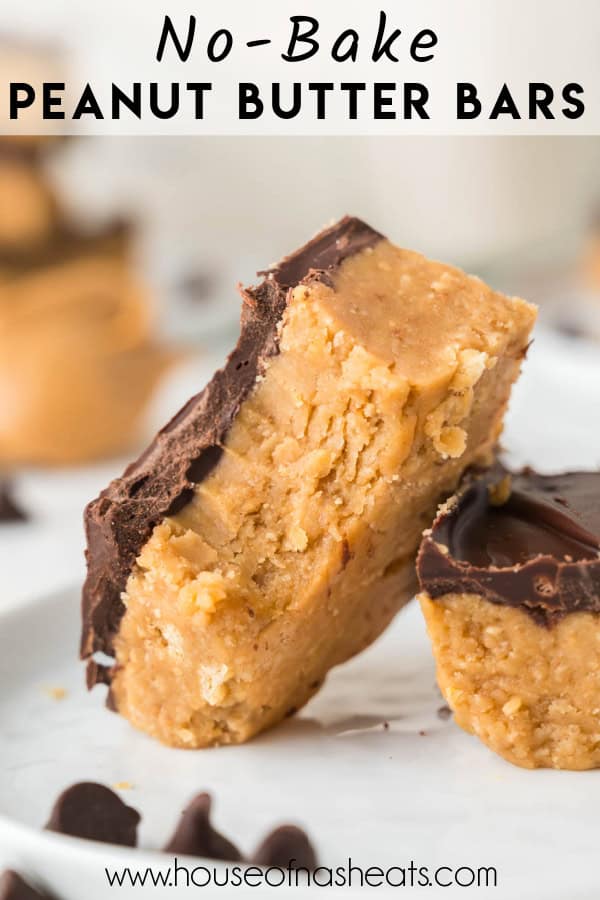 A no-bake peanut butter bar with a bite taken out of it on a white plate leaning against another bar with text overlay.