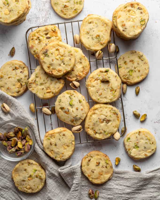 Overhead view of Pistachio Shortbread cookies piled up on a wire rack.