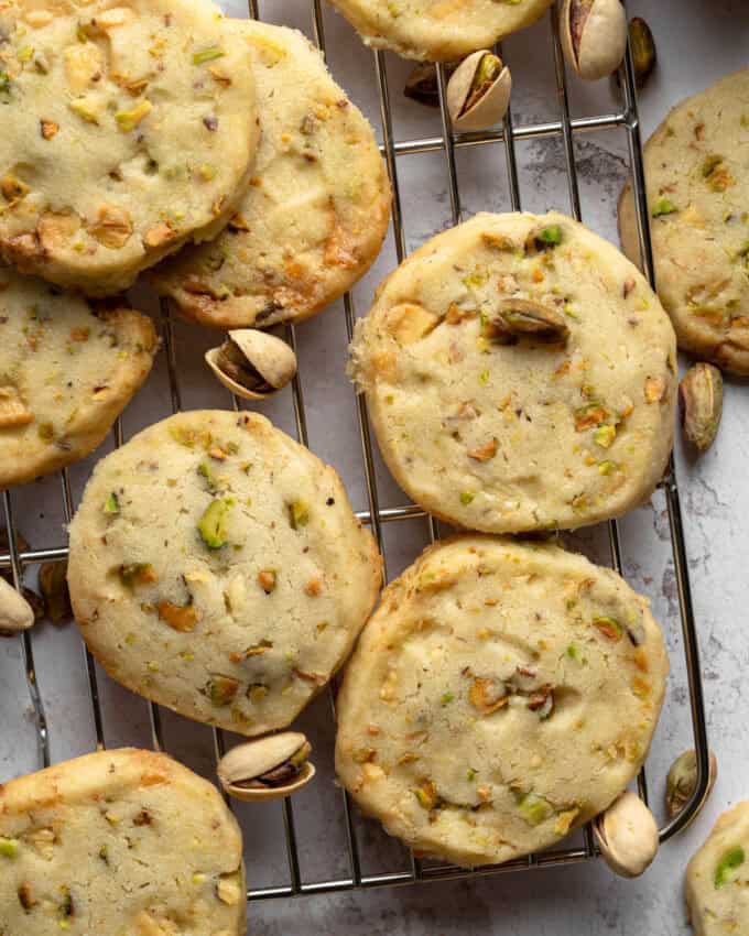 Overhead view of Pistachio Shortbread cookies piled up on a wire rack.