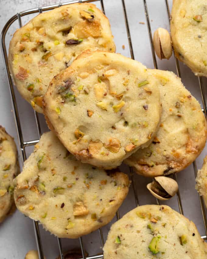 Overhead view of Pistachio Shortbread cookies piled up on a wire rack.