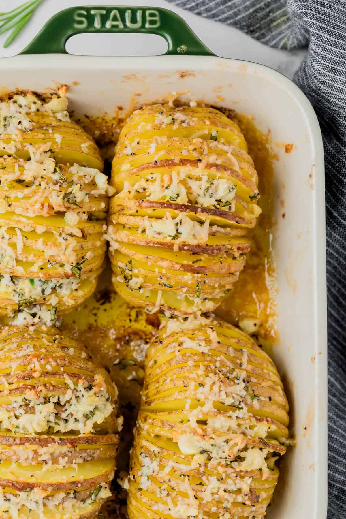 An overhead image of hasselback potatoes in a casserole dish.