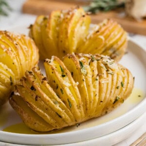 Hasselback potatoes on a white plate.