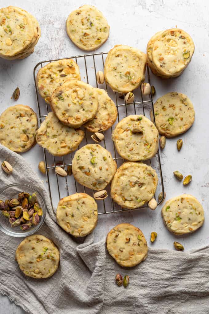 Overhead view of Pistachio Shortbread cookies piled up on a wire rack.