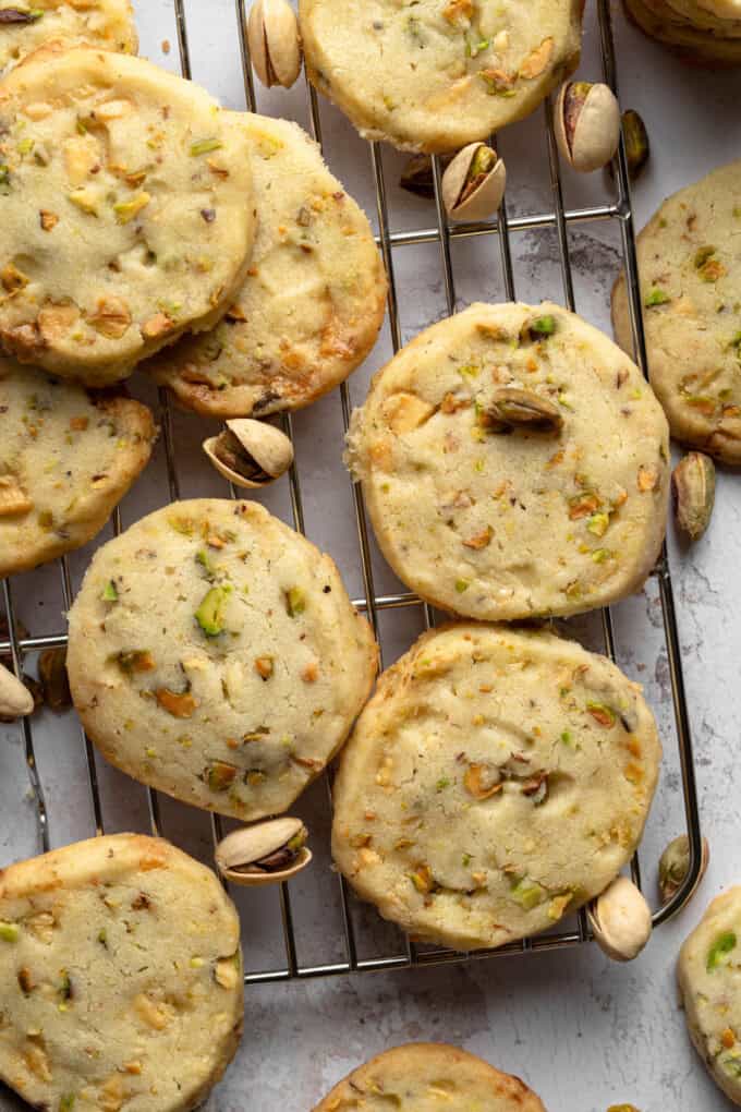 Overhead view of Pistachio Shortbread cookies piled up on a wire rack.