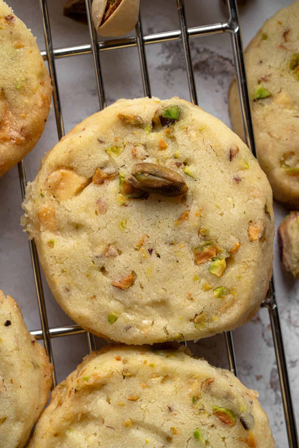 Close up overhead view of Pistachio Shortbread cookies on a wire rack.