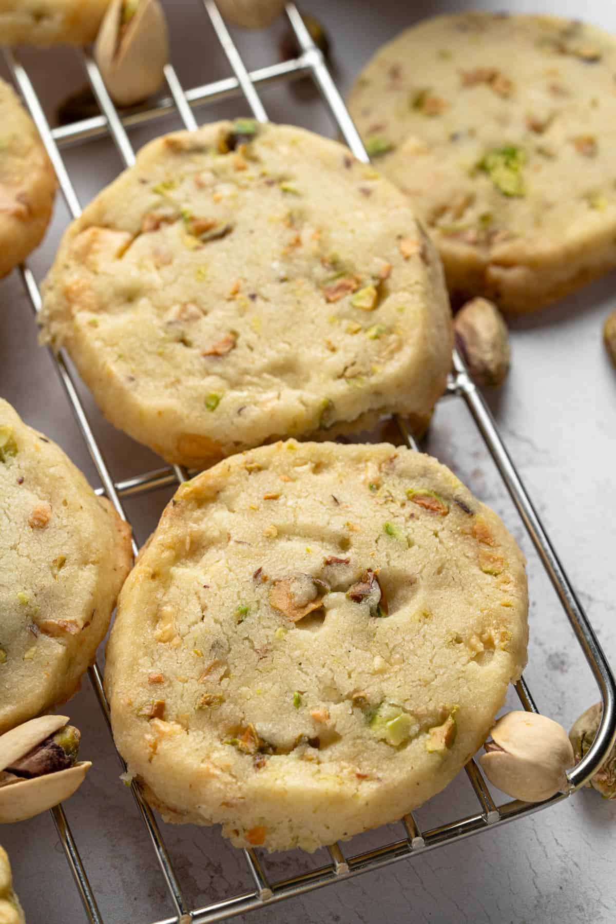 Close up angled view of Pistachio Shortbread cookies on a wire rack.