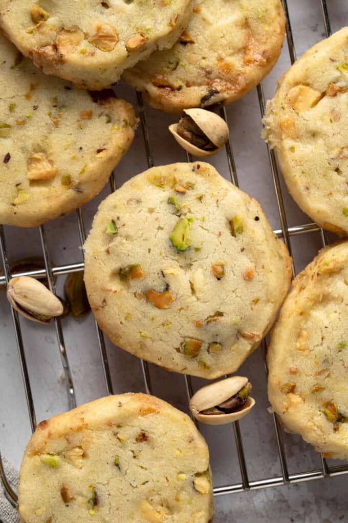 Close up overhead view of Pistachio Shortbread cookies piled up on a wire rack.