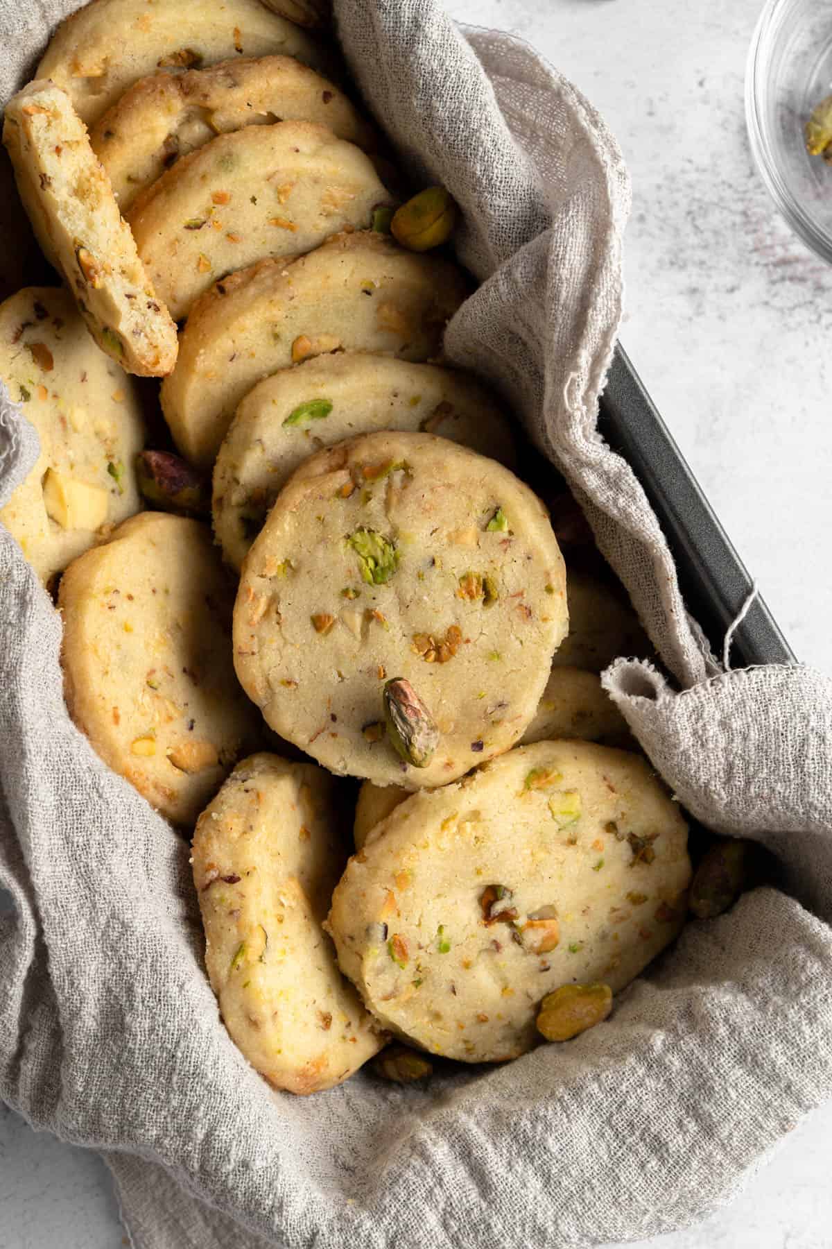 Overhead view of Pistachio Shortbread cookies in a cloth-lined loaf pan.