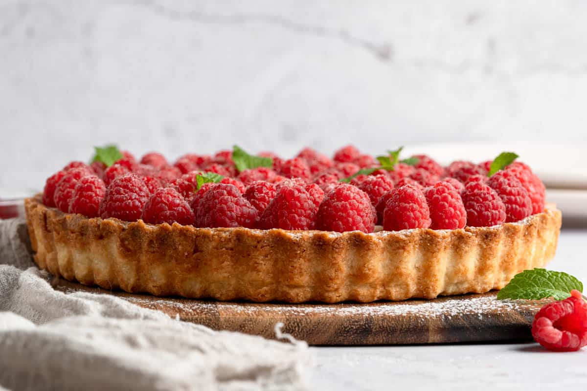 A side view of a raspberry tart.