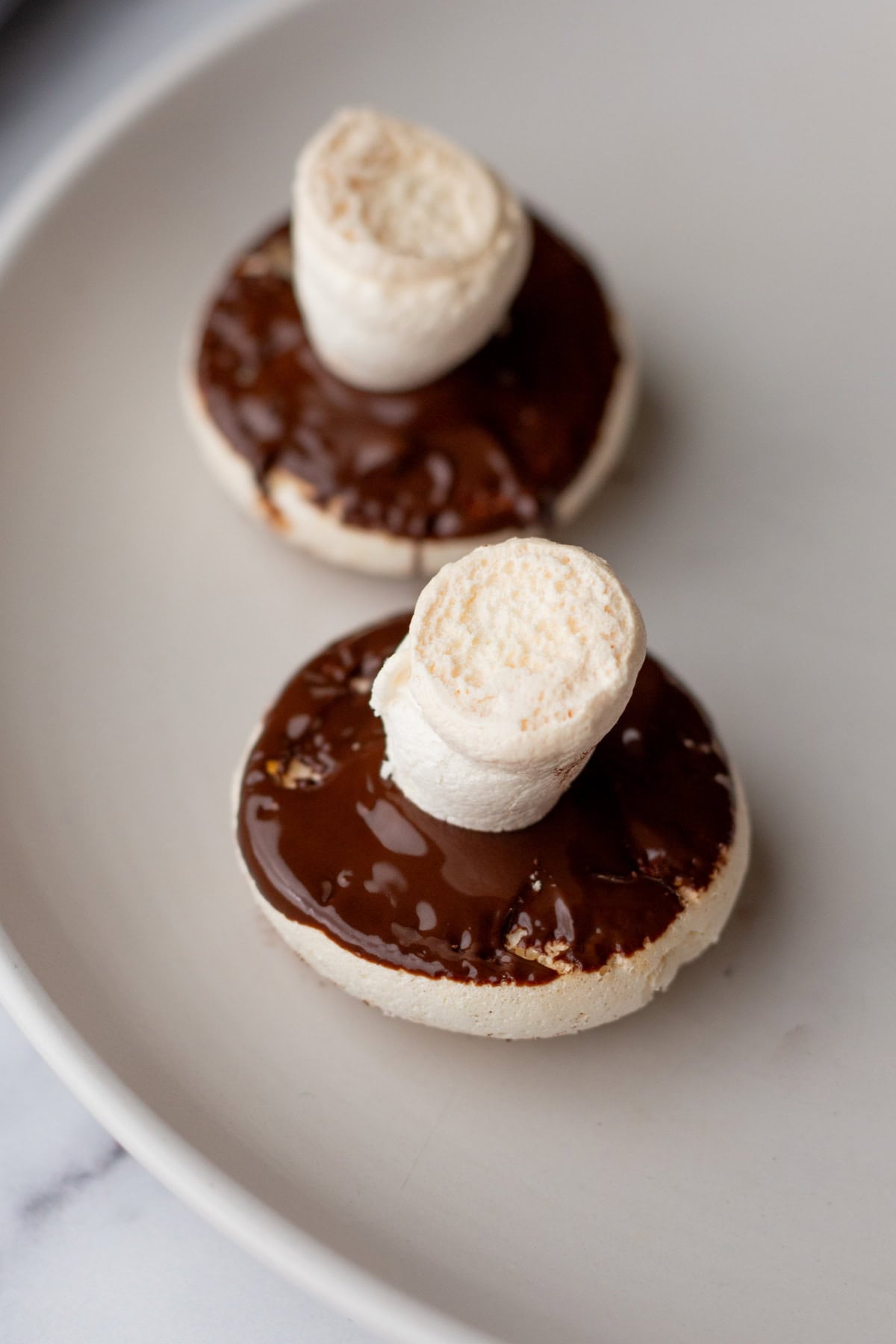 Attaching meringue "stems" to chocolate dipped "tops" to make meringue mushrooms.