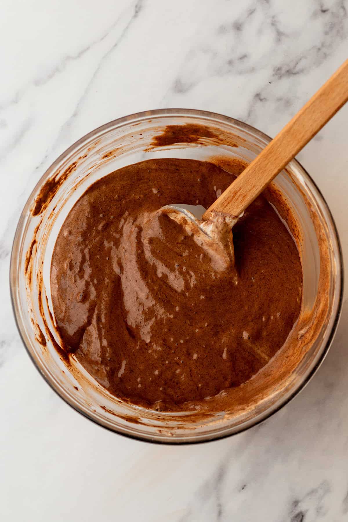 Chocolate sponge cake batter in a mixing bowl.