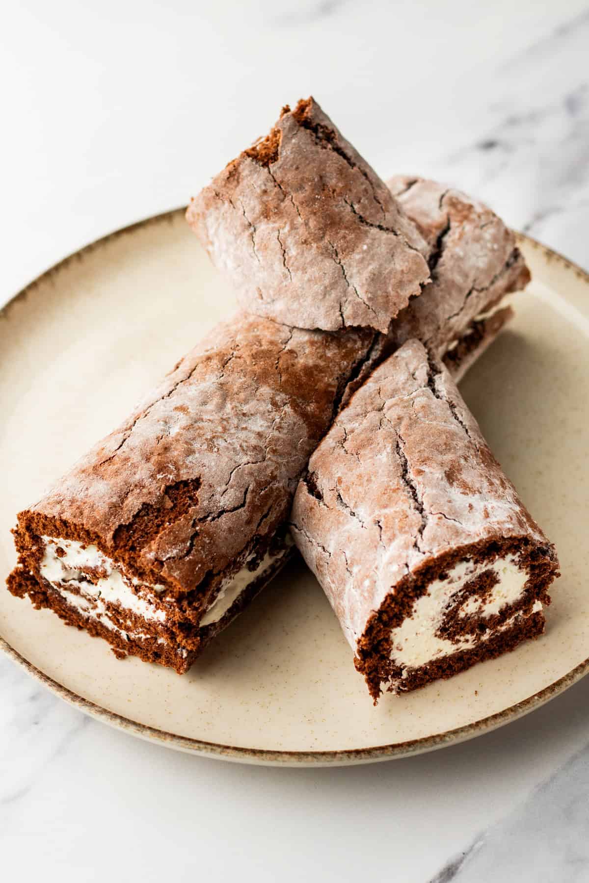 Assembling a buche de noel cake on a plate.