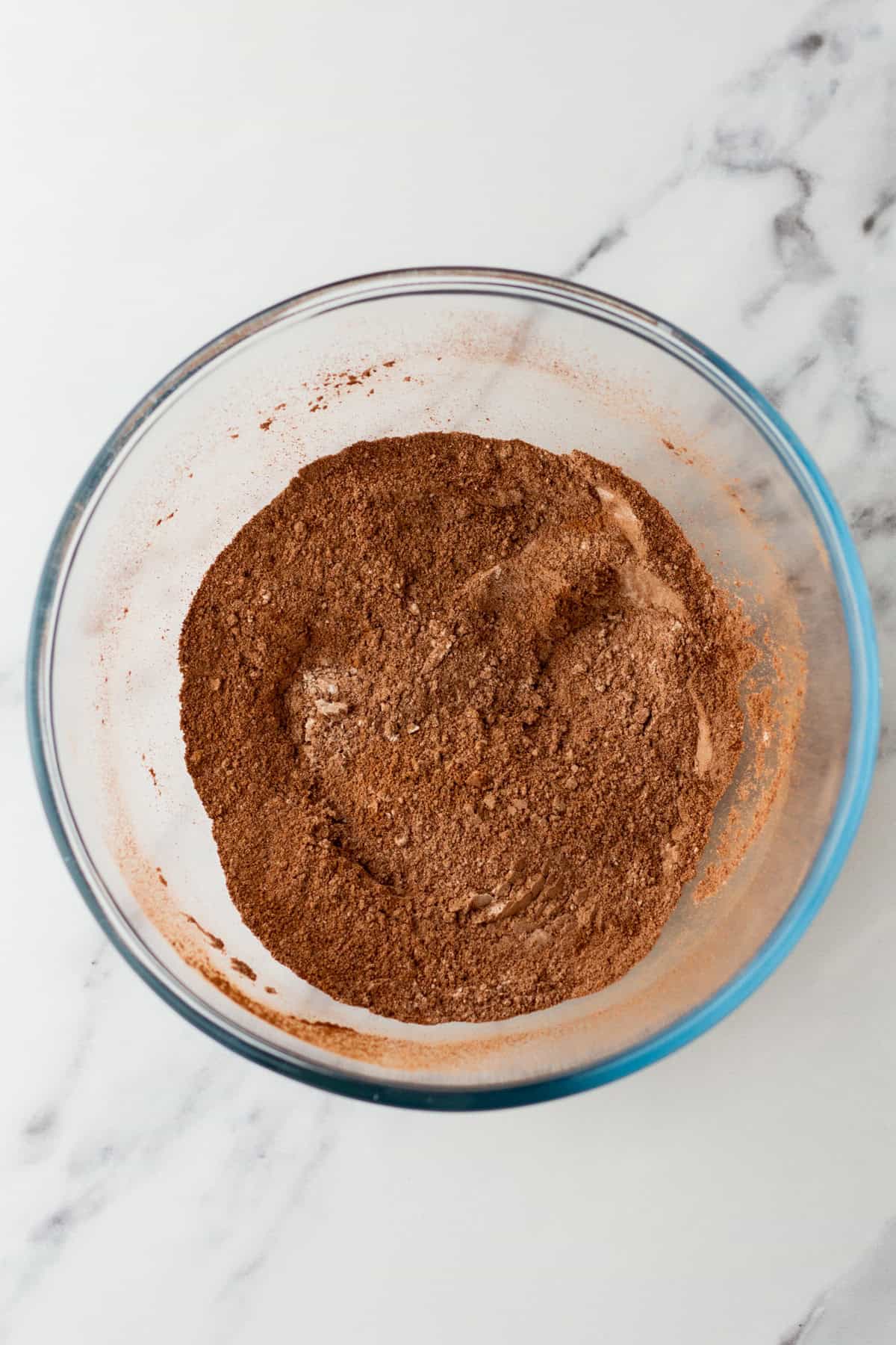 Dry ingredients whisked in a glass bowl.