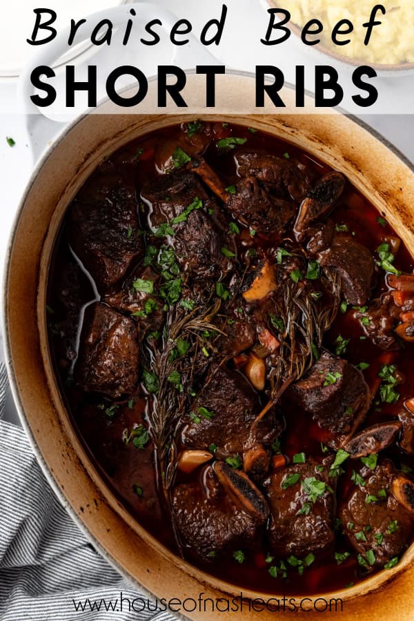 An overhead image of a dutch oven filled with braised beef short ribs with text overlay.