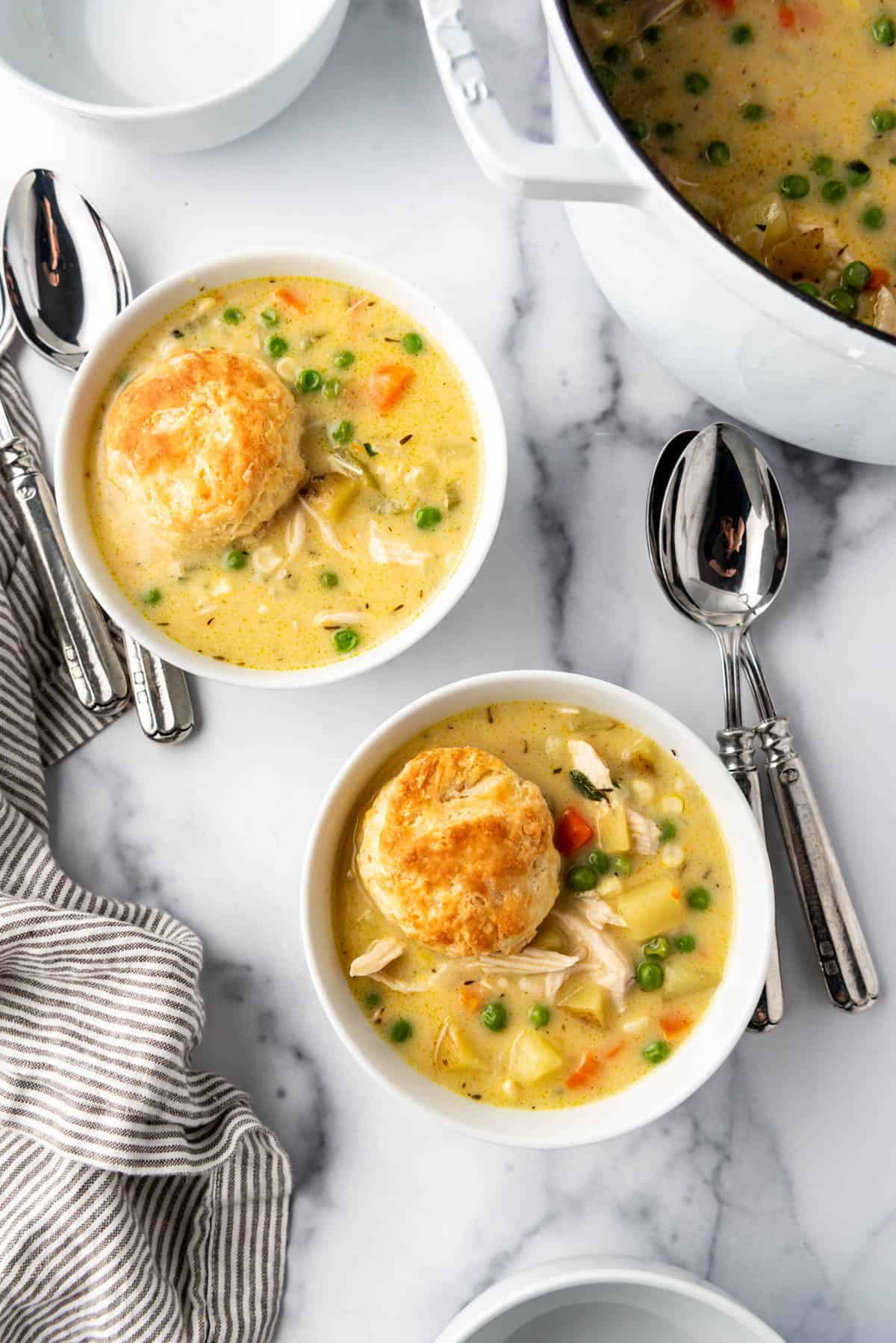 An overhead image of bowls of chicken pot pie soup.