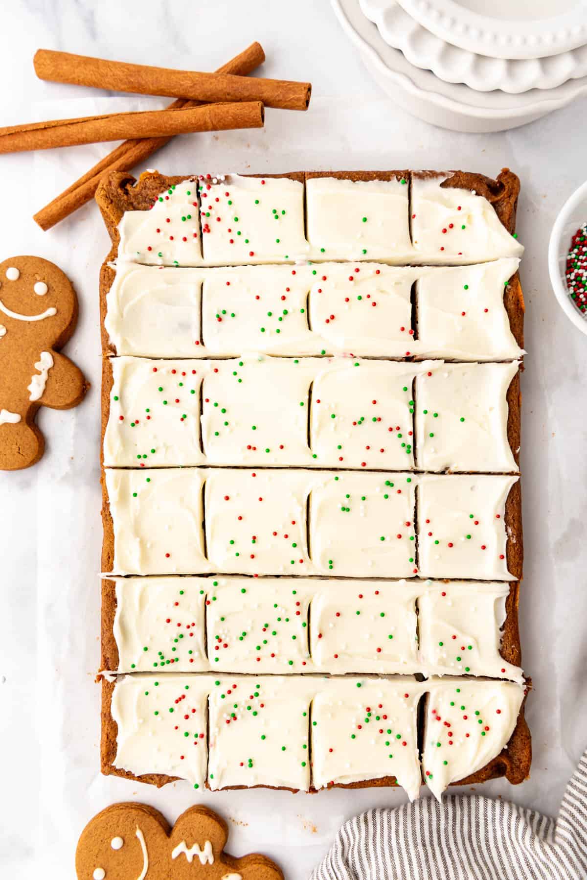 Frosted gingerbread cookie bars cut into 24 squares.