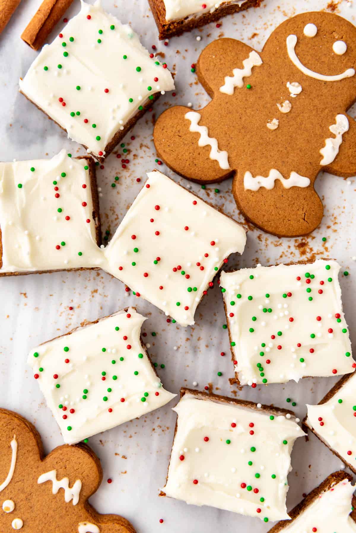 An overhead image of frosted gingerbread bars and gingerbread men cookies.