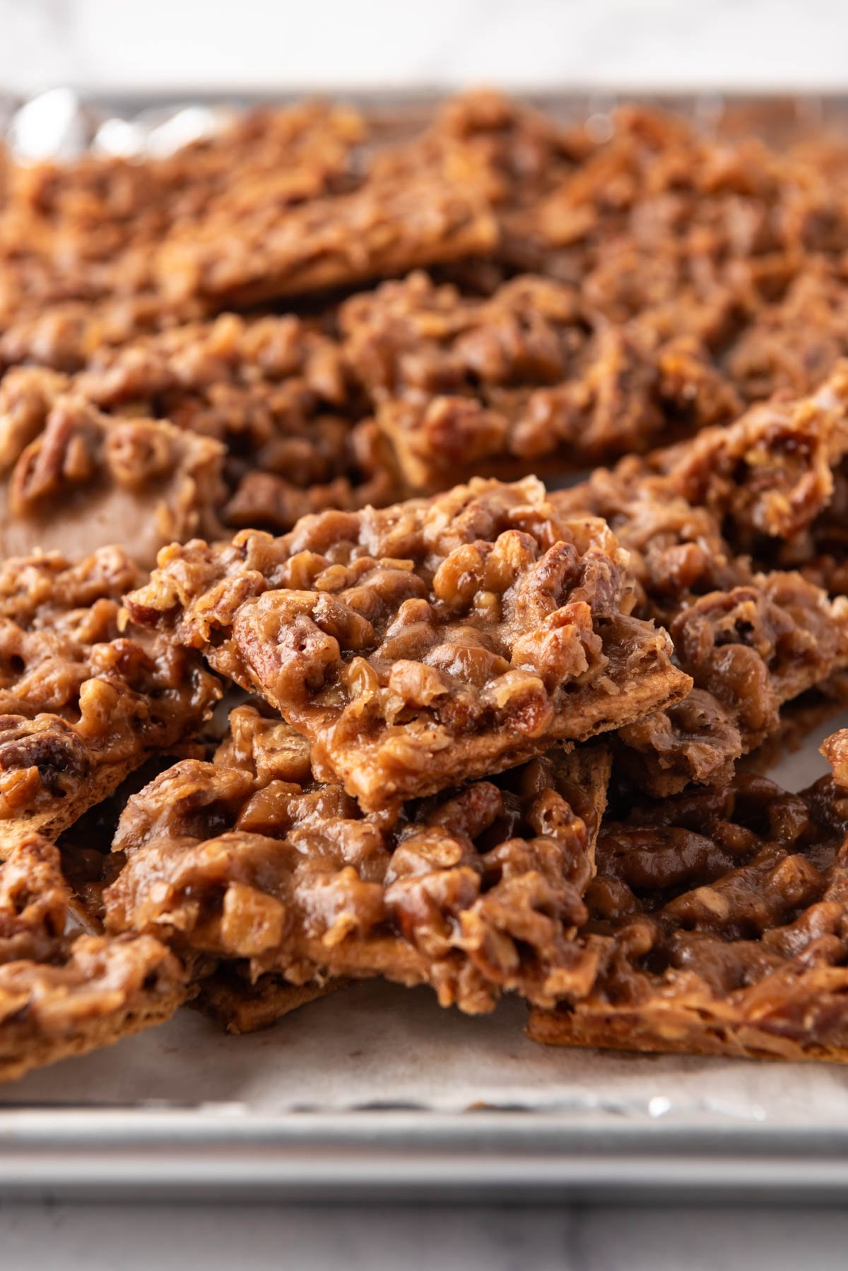 A close up image of graham cracker toffee with chopped pecans.