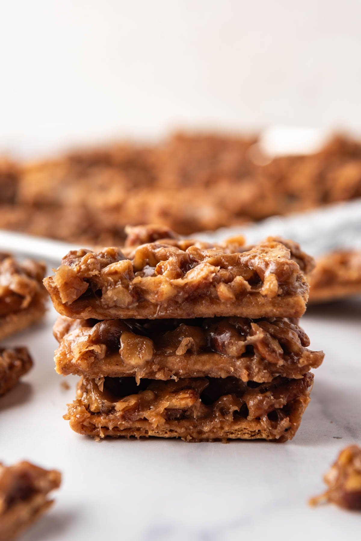 Three stacked pieces of pecan pie bark.