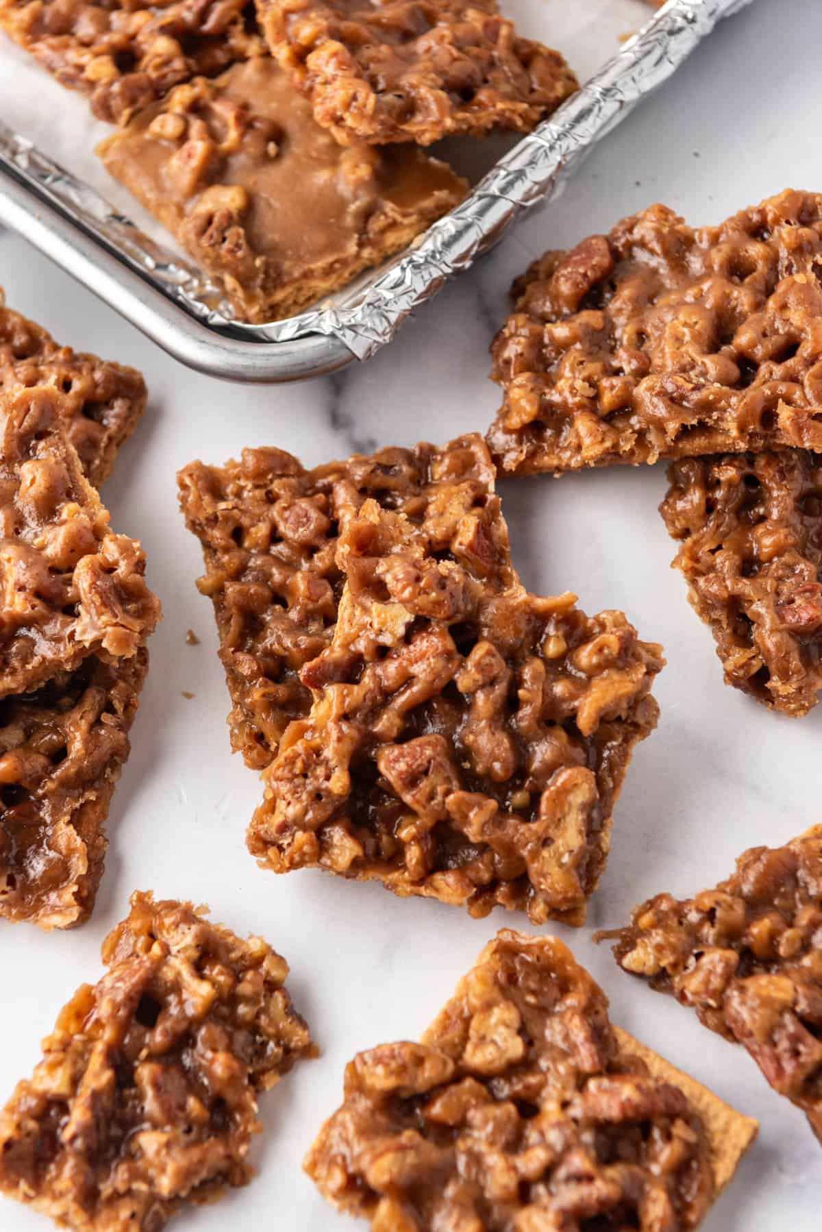 An image of pecan pie bark squares on a white surface.