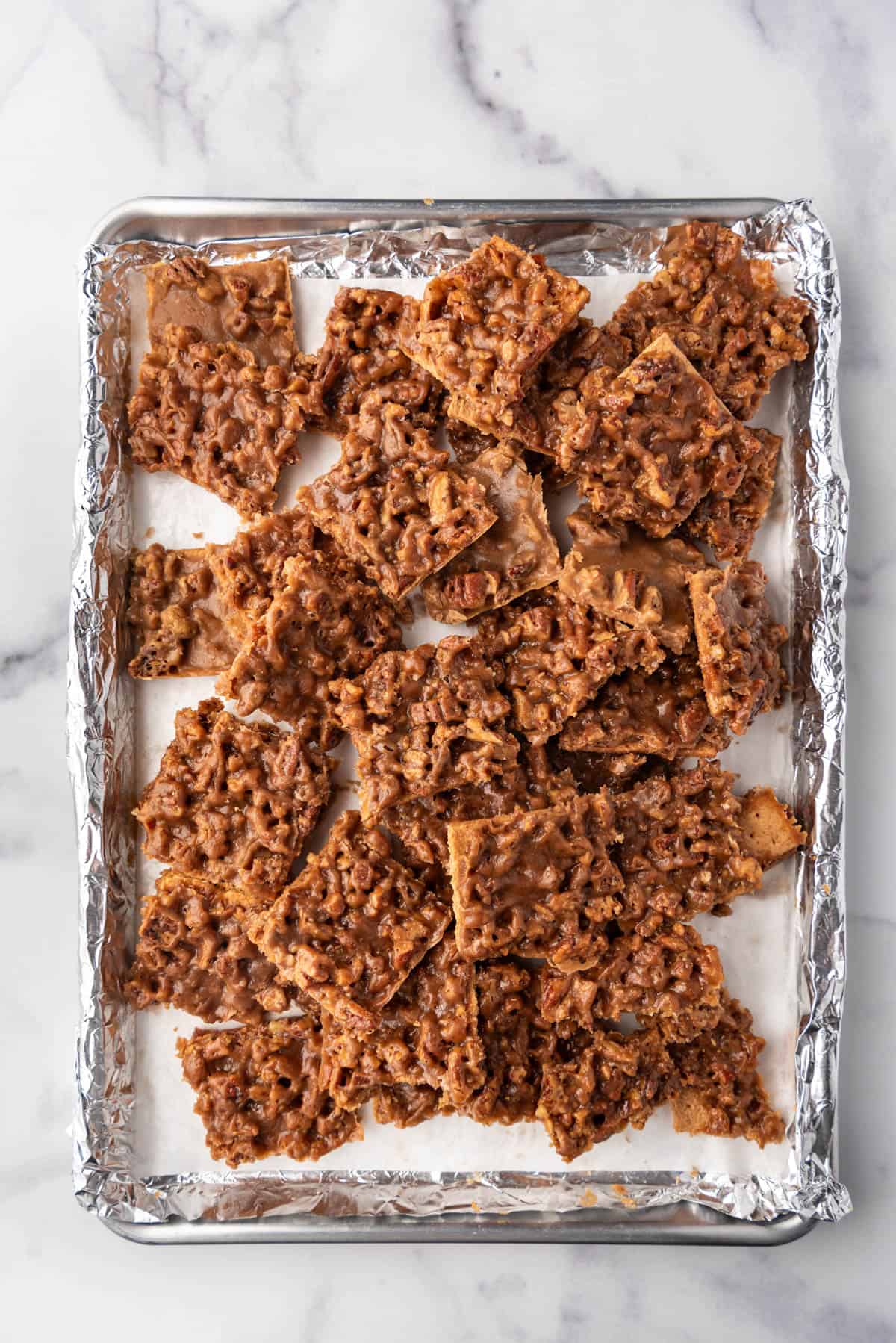 An overhead image of a  baking sheet full of pecan pie bark.