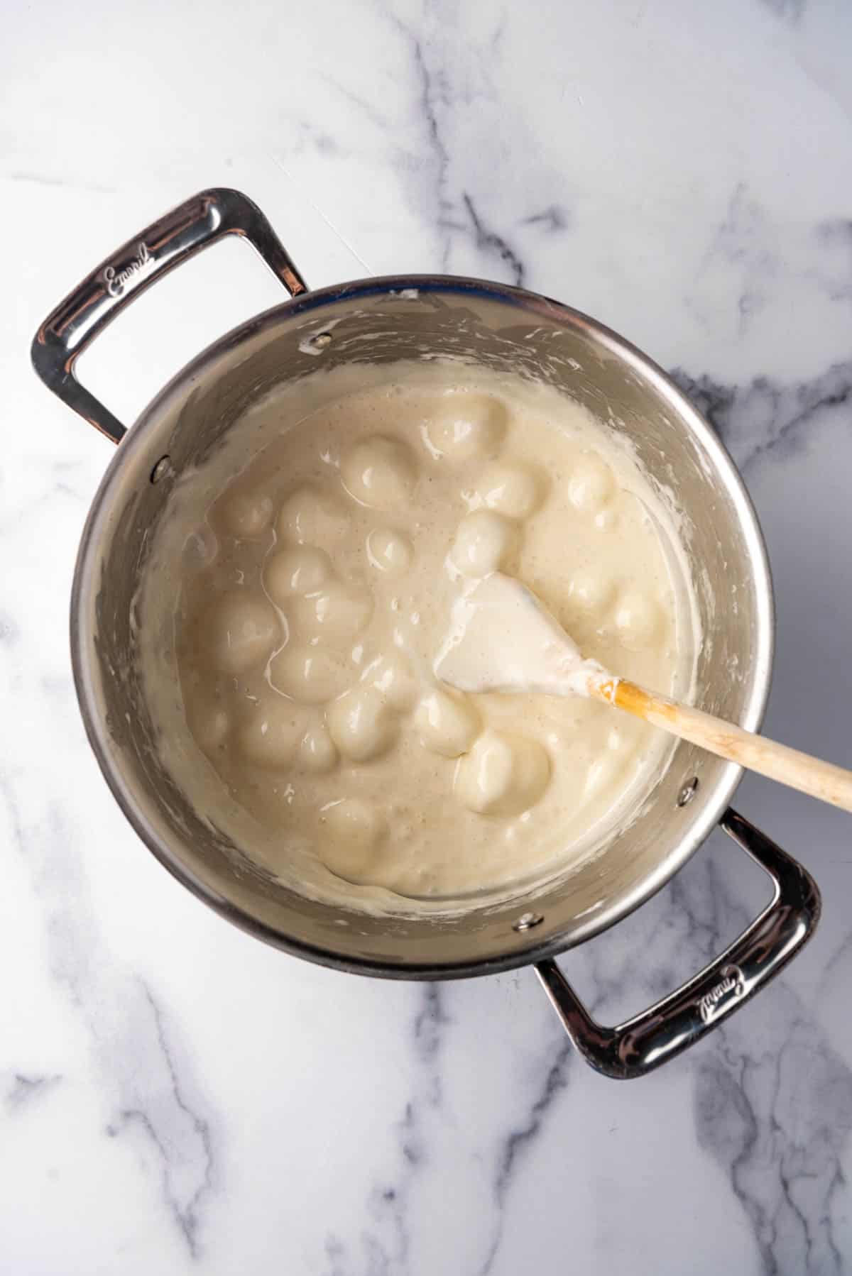 Melted marshmallows and butter in a pot.