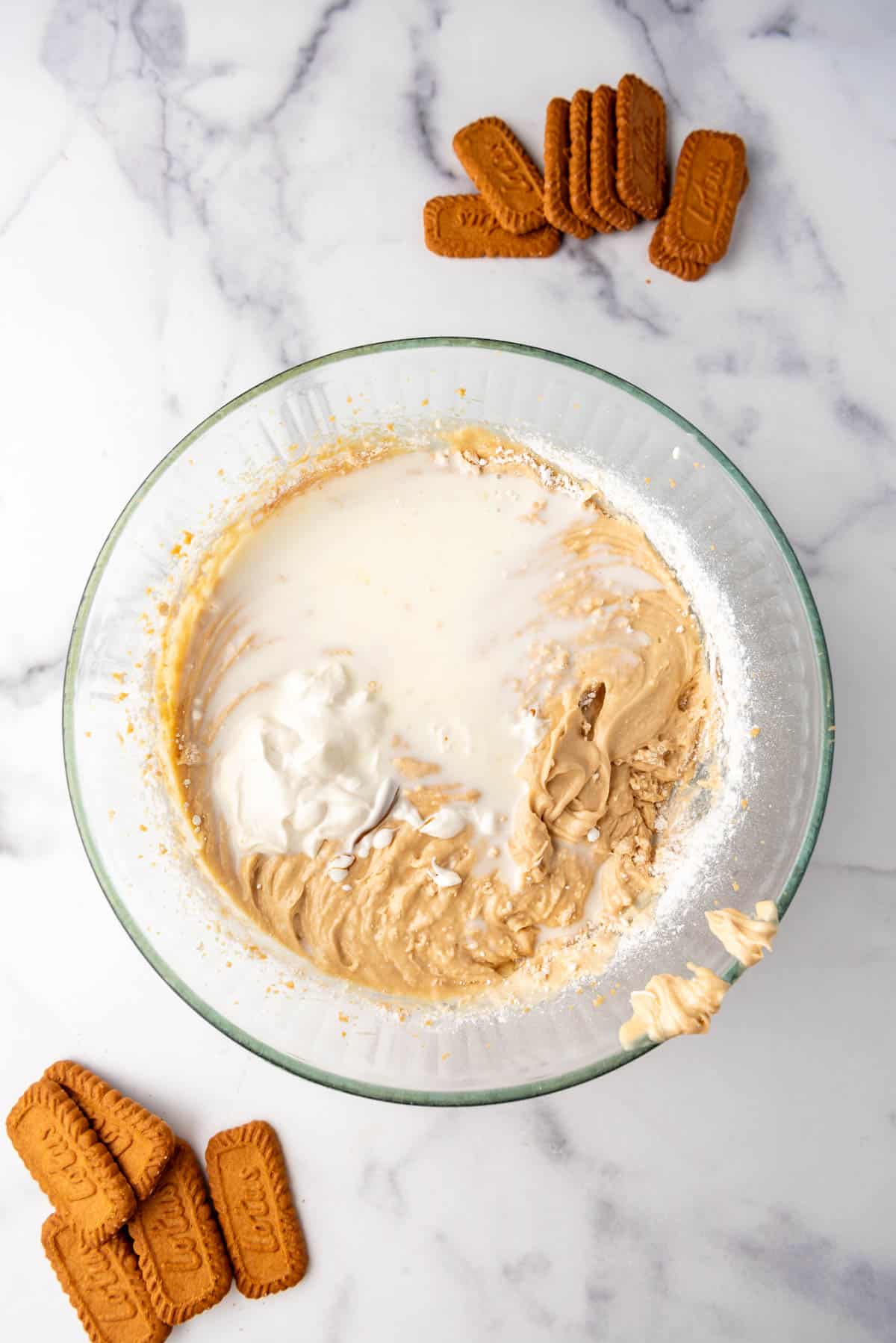 Adding sour cream and  milk to cake batter.