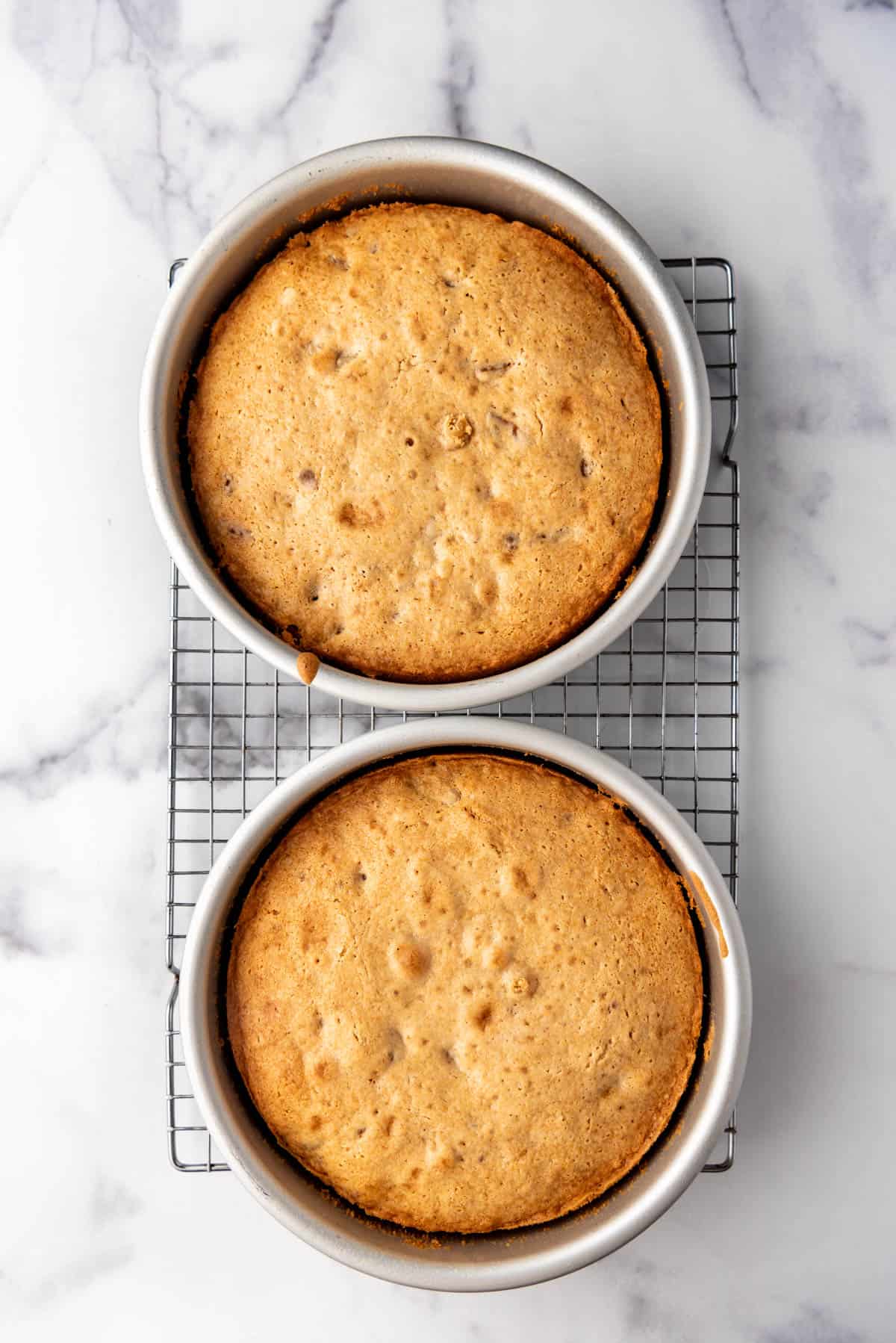 Baked cake layers on a wire cooling rack.