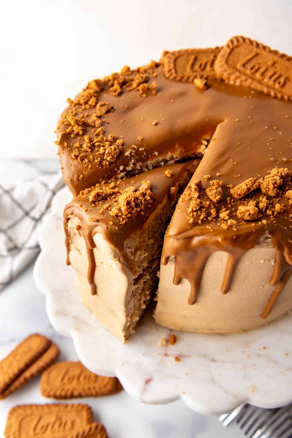 An overhead image of a slice of Biscoff cookie butter cake being removed from the cake.