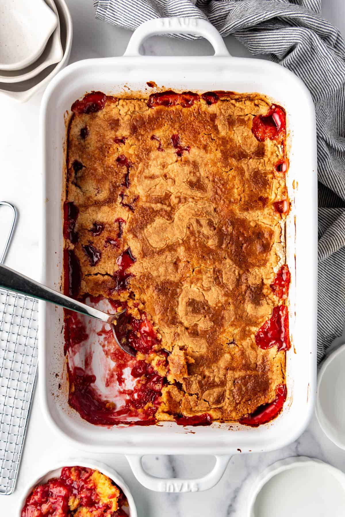 An overhead image of a pan of cherry pineapple dump cake.