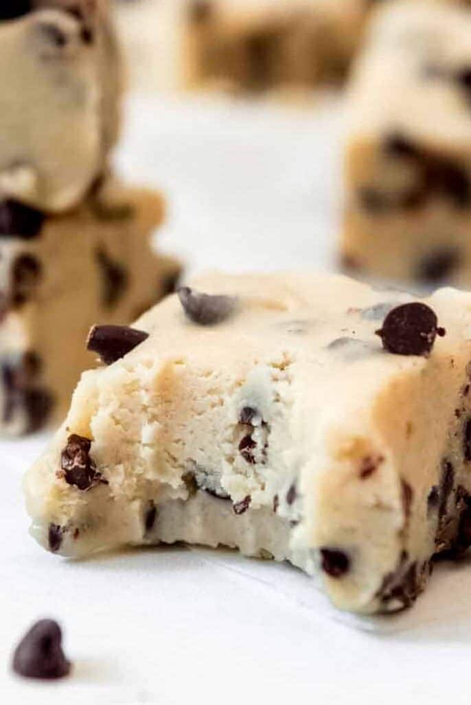 A piece of cookie dough fudge with a bite taken out of it.