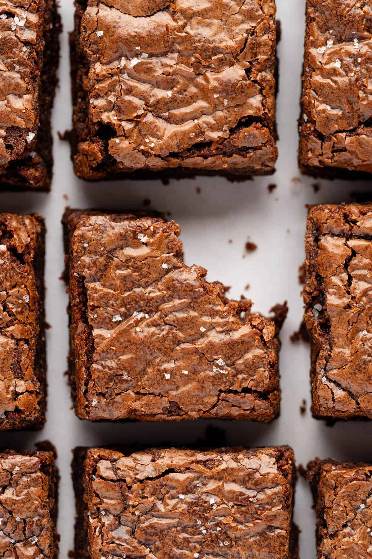 Brownie squares with a bite taken out of one of them.